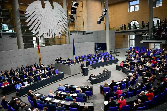 A general view shows German Chancellor Friedrich Merz (C) addressing parliamentarians during a general debate on the budget of the Chancellery at the Bundestag, the lower house of parliament, in Berlin, on July 9, 2025, while the . (Photo by Tobias SCHWARZ / AFP)