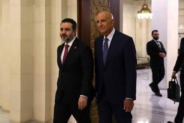 Syrian interim Foreign Minister Asaad al-Shaibani (L) accompanies US Special Envoy to Syria Thomas Barrack, to meet the president in Damascus on July 9, 2025. (Photo by Bakr ALkasem / AFP)