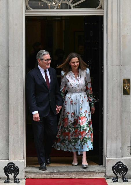 Britain's Prime Minister Keir Starmer and his wife Victoria Starmer exit 10 Downing Street to greet France's President Emmanuel Macron and his wife Brigitte Macron, ahead of a lunch, in London, on July 9, 2025, on the second day of the President's three-day state visit to Britain. French President Emmanuel Macron will have lunch with Britain's Prime Minister Keir Starmer on Wednesday, ahead of the two leaders on Thursday co-hosting the 37th Franco-British Summit, where they are set to discuss opportunities to strengthen defence ties. (Photo by Oli SCARFF / AFP)