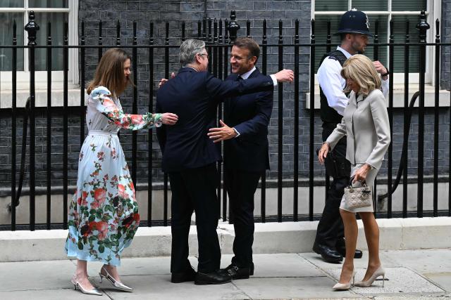 France's President Emmanuel Macron and his wife Brigitte Macron are greeted by Britain's Prime Minister Keir Starmer and his wife Victoria Starmer, as they arrive at 10 Downing Street ahead of a lunch, in London on July 9, 2025, on the second day of their three-day state visit to Britain. French President Emmanuel Macron will have lunch with Britain's Prime Minister Keir Starmer on Wednesday, ahead of the two leaders on Thursday co-hosting the 37th Franco-British Summit, where they are set to discuss opportunities to strengthen defence ties. (Photo by Oli SCARFF / AFP)