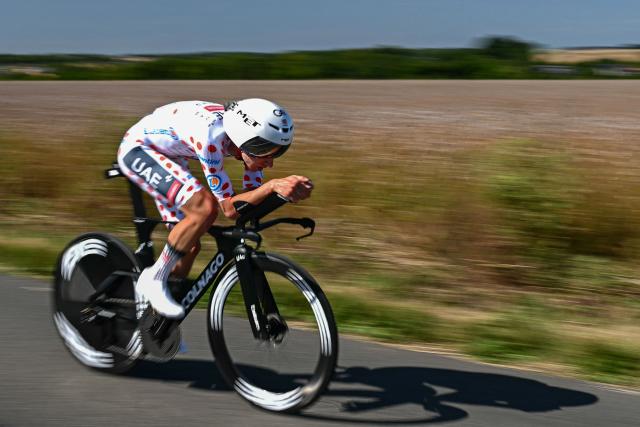 UAE Team Emirate - XRG team's Slovenian rider Tadej Pogacar wearing the best climber's polka dot (dotted) jersey cycles during the 5th stage of the 112th edition of the Tour de France cycling race, 33 km individual time trial starting and finishing in Caen, northwestern France, on July 9, 2025. (Photo by Loic VENANCE / AFP)