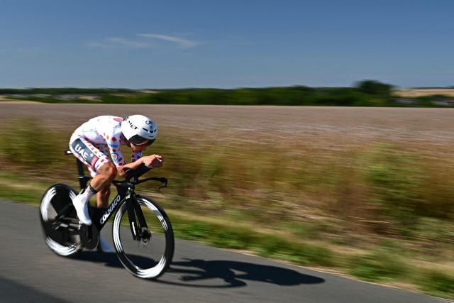 UAE Team Emirate - XRG team's Slovenian rider Tadej Pogacar wearing the best climber's polka dot (dotted) jersey cycles during the 5th stage of the 112th edition of the Tour de France cycling race, 33 km individual time trial starting and finishing in Caen, northwestern France, on July 9, 2025. (Photo by Loic VENANCE / AFP)