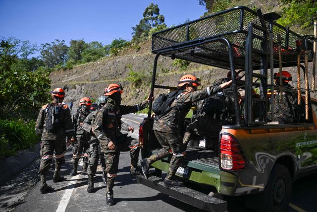Rescuers work at a road blocked by a landslide after a series of earthquakes in Santa Maria de Jesus, Guatemala, on July 9, 2025. Two people were killed when their vehicle was buried under a landslide after a series of earthquakes shook much of the Central American country on Tuesday, Guatemalan authorities said. (Photo by JOHAN ORDONEZ / AFP)