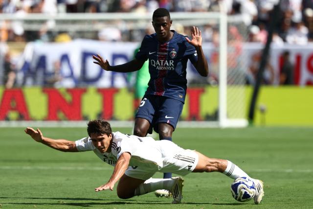 Paris Saint-Germain's Portuguese defender #25 Nuno Mendes adn Real Madrid's Spanish forward #30 Gonzalo Garcia fight for the ball during the FIFA Club World Cup 2025 semifinal football match between France's Paris Saint-Germain and Spain's Real Madrid at the MetLife stadium in East Rutherford, New Jersey on July 9, 2025. (Photo by FRANCK FIFE / AFP)