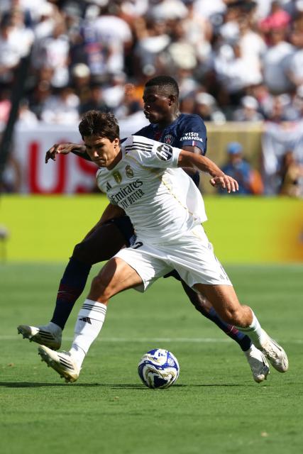 Paris Saint-Germain's Portuguese defender #25 Nuno Mendes adn Real Madrid's Spanish forward #30 Gonzalo Garcia fight for the ball during the FIFA Club World Cup 2025 semifinal football match between France's Paris Saint-Germain and Spain's Real Madrid at the MetLife stadium in East Rutherford, New Jersey on July 9, 2025. (Photo by FRANCK FIFE / AFP)