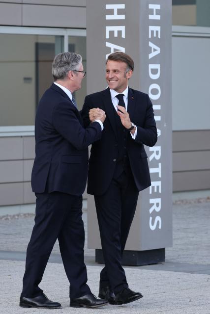 Britain's Prime Minister Keir Starmer (L) and France's President Emmanuel Macron gesture as they leave following a meeting of the Coalition of the Willing at a military base at Northwood Headquarters in north-west London, on July 10, 2025. (Photo by Ludovic MARIN / POOL / AFP)
