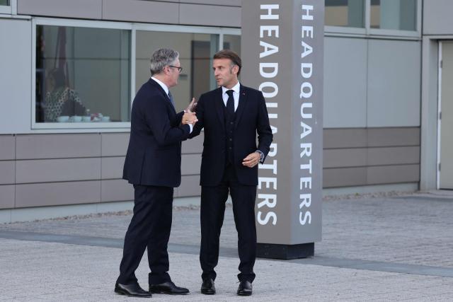 Britain's Prime Minister Keir Starmer (L) and France's President Emmanuel Macron gesture as they leave following a meeting of the Coalition of the Willing at a military base at Northwood Headquarters in north-west London, on July 10, 2025. (Photo by Ludovic MARIN / POOL / AFP)