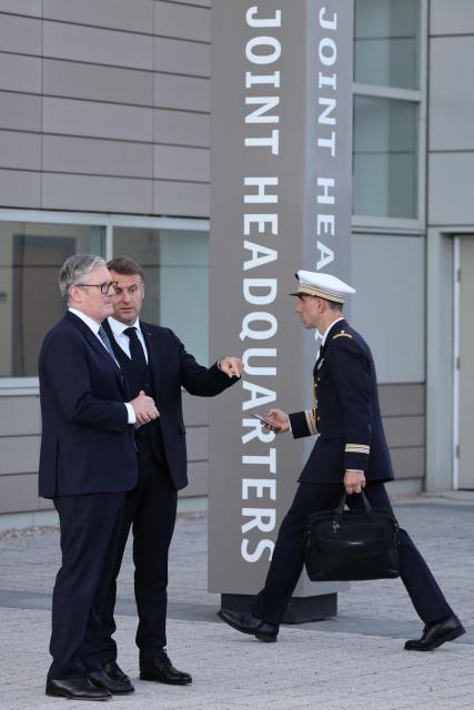 Britain's Prime Minister Keir Starmer (L) and France's President Emmanuel Macron gesture as they leave following a meeting of the Coalition of the Willing at a military base at Northwood Headquarters in north-west London, on July 10, 2025. (Photo by Ludovic MARIN / POOL / AFP)