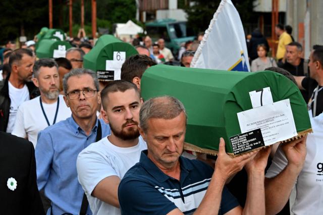 Bosnian Muslims men carry caskets with the remains of victims ahead of the burial ceremony at the memorial cemetery in village of Potocari, near the Eastern-Bosnian town of Srebrenica, on July 10, 2025, marking the 30th Anniversary of the Srebrenica genocide. Thousands of people are expected to gather in Srebrenica on July 11 to commemorate the genocide committed 30 years ago by Bosnian Serb forces, one of Europe's worst atrocities since World War II. The remains of seven victims of the massacre will be laid to rest during Friday'sc ommemorations, marking the bloodiest episode of Bosnia's inter-ethnic war in the 1990s. The war broke out after Bosnia declared independence, a move supported by the country's Muslims and Croats but rejected by Serbs.
On July 11, 1995, after a siege of more than three months, Bosnian Serb forces captured the eastern town -- a UN-protected enclave at the time. (Photo by Elvis BARUKCIC / AFP)
