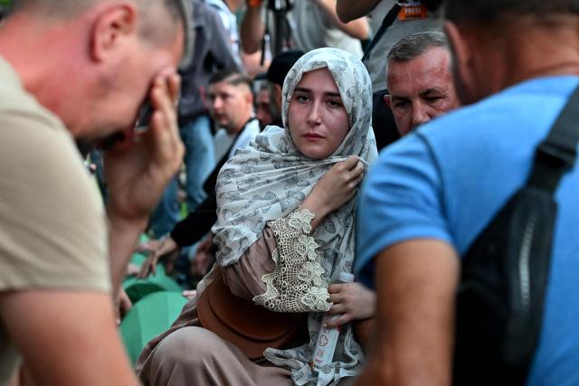 Bosnian Muslims mourn over the caskets with the remains of their relatives ahead of a burial ceremony at the memorial cemetery in village of Potocari, near the eastern Bosnian town of Srebrenica, on July 10, 2025, marking the 30th anniversary of the Srebrenica genocide. Thousands of people are expected to gather in Srebrenica on July 11 to commemorate the genocide committed 30 years ago by Bosnian Serb forces, one of Europe's worst atrocities since World War II. The remains of seven victims of the massacre will be laid to rest during Friday'sc ommemorations, marking the bloodiest episode of Bosnia's inter-ethnic war in the 1990s. The war broke out after Bosnia declared independence, a move supported by the country's Muslims and Croats but rejected by Serbs.
On July 11, 1995, after a siege of more than three months, Bosnian Serb forces captured the eastern town -- a UN-protected enclave at the time. (Photo by Elvis BARUKCIC / AFP)