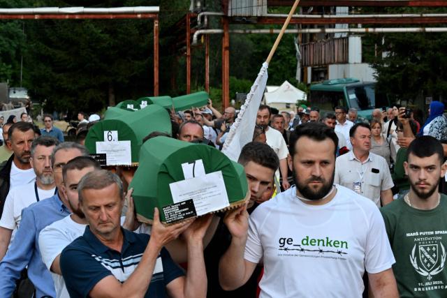 Bosnian Muslim men carry caskets with the remains of victims ahead of the burial ceremony at the memorial cemetery in village of Potocari, near the Eastern-Bosnian town of Srebrenica, on July 10, 2025, marking the 30th Anniversary of the Srebrenica genocide. Thousands of people are expected to gather in Srebrenica on July 11 to commemorate the genocide committed 30 years ago by Bosnian Serb forces, one of Europe's worst atrocities since World War II. The remains of seven victims of the massacre will be laid to rest during Friday'sc ommemorations, marking the bloodiest episode of Bosnia's inter-ethnic war in the 1990s. The war broke out after Bosnia declared independence, a move supported by the country's Muslims and Croats but rejected by Serbs.
On July 11, 1995, after a siege of more than three months, Bosnian Serb forces captured the eastern town -- a UN-protected enclave at the time. (Photo by Elvis BARUKCIC / AFP)