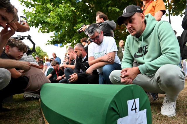 Bosnian Muslims mourn over the caskets with the remains of their relatives ahead of a burial ceremony at the memorial cemetery in village of Potocari, near the eastern Bosnian town of Srebrenica, on July 10, 2025, marking the 30th anniversary of the Srebrenica massacre. Thousands of people are expected to gather in Srebrenica on July 11 to commemorate the genocide committed 30 years ago by Bosnian Serb forces, one of Europe's worst atrocities since World War II. The remains of seven victims of the massacre will be laid to rest during Friday'sc ommemorations, marking the bloodiest episode of Bosnia's inter-ethnic war in the 1990s. The war broke out after Bosnia declared independence, a move supported by the country's Muslims and Croats but rejected by Serbs.
On July 11, 1995, after a siege of more than three months, Bosnian Serb forces captured the eastern town -- a UN-protected enclave at the time. (Photo by Elvis BARUKCIC / AFP)