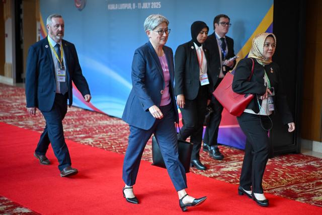 Australia's Minister for Foreign Affairs Penny Wong (C) walks between meetings during the 58th ASEAN Foreign Ministers' meeting and related meetings at the Convention Centre in Kuala Lumpur on July 11, 2025. (Photo by Mandel NGAN / POOL / AFP)