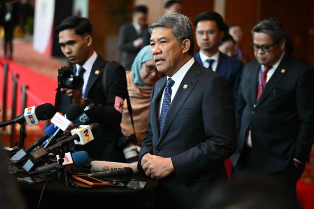 Malaysia's Foreign Affairs Minister Mohamad Hasan (C) takes part in a press briefing during the 58th ASEAN Foreign Ministers' meeting and related meetings at the Convention Centre in Kuala Lumpur on July 11, 2025. (Photo by Mandel NGAN / POOL / AFP)