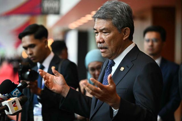 Malaysia's Foreign Affairs Minister Mohamad Hasan (R) takes part in a press briefing during the 58th ASEAN Foreign Ministers' meeting and related meetings at the Convention Centre in Kuala Lumpur on July 11, 2025. (Photo by Mandel NGAN / POOL / AFP)