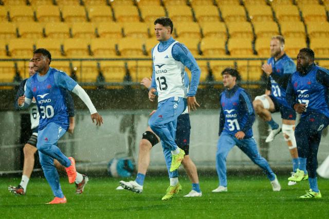 France players warm up during the captain's run ahead of the second international rugby Test match against New Zealand, at Sky Stadium in Wellington on July 11, 2025. (Photo by Marty MELVILLE / AFP)