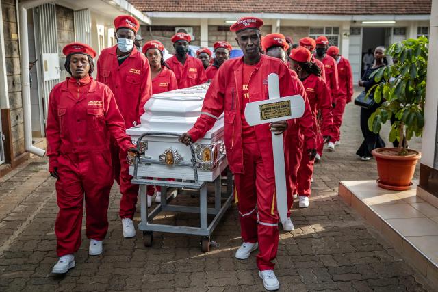 TOPSHOT - Youths push the casket of Boniface Kariuki, a street hawker who died from gunshot wounds days after he was shot by Kenyan police during nationwide protests against police conduct and government policies, ahead of his funeral at a mortuary in Nairobi on July 11, 2025. (Photo by Luis TATO / AFP)