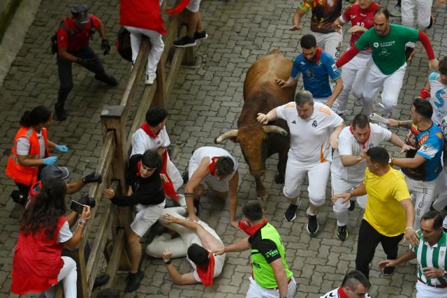 Participants run ahead of Jandilla bulls during the fifth running of the bulls of the San Fermin festival in Pamplona, northern Spain, on July 11, 2025. Thousands of people every year attend the week-long festival and its famous "encierros" or bull runs, every day at 8:00 a.m. through the narrow streets of the old town over an 850 meters (yard) course while runners ahead of them try to stay close to the bulls without falling over or being gored. (Photo by MIGUEL RIOPA / AFP)