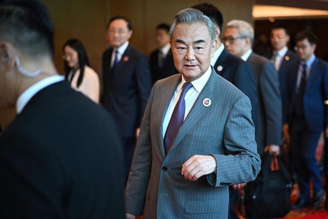 China's Foreign Minister Wang Yi walks between meetings during the 58th ASEAN Foreign Ministers’ meeting and related meetings at the Convention Centre in Kuala Lumpur on July 11, 2025. (Photo by Mandel NGAN / POOL / AFP)