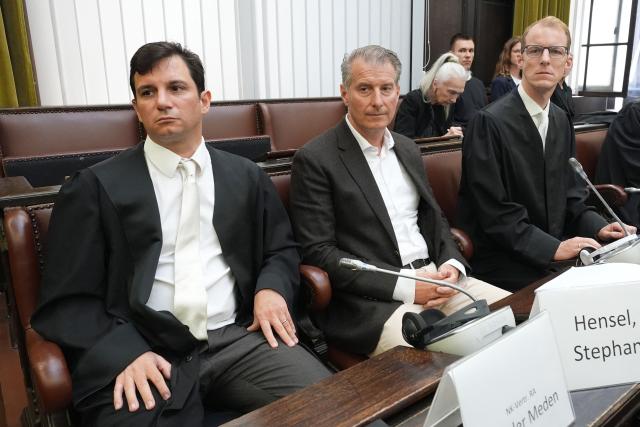Joint plaintiff Stephan Hensel (C), former husband of defendant Christina Block (not in picture), sits next to his lawyers Philip von der Meden (L) and Christoph Henckel at court prior to the start of a trial against German entrepreneur and gastronome Christina Block and her partner German former sports journalist Gerhard Delling (both not in picture) at the district court in Hamburg, northern Germany, on July 11, 2025. The public prosecutor's office accuses Block, heiress of a steakhouse chain, of ordering the abduction of her daughter, born in 2010, and her son, born in 2013. Block's partner Gerhard Delling has been charged with aiding and abetting. According to the indictment, the background to this is an escalating custody dispute over many years between Block and her former husband, who have four children together. The latter kept the two youngest children with him in August 2021 after an agreed visit to Gravenstein in southern Denmark near the German border, where he had been living for some time. (Photo by Marcus Brandt / POOL / AFP)