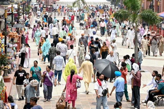 People visit the Heritage Street in Amritsar on July 11, 2025, observed as the World Population Day. (Photo by Narinder NANU / AFP)