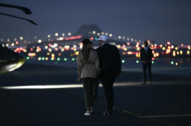 US President Donald Trump and First Lady Melania Trump walk towards Marine One upon arrival at Morristown Municipal Airport in Morristown, New Jersey, on July 11, 2025, on their way to spend the weekend at their residence in Bedminster, New Jersey. Earlier in the day, President Trump and the First Lady visited the Kerrville, Texas, after the area was devasted by severe flooding over the July 4 holiday weekend. At least 120 people are dead and more than 170 still missing. (Photo by Brendan SMIALOWSKI / AFP)