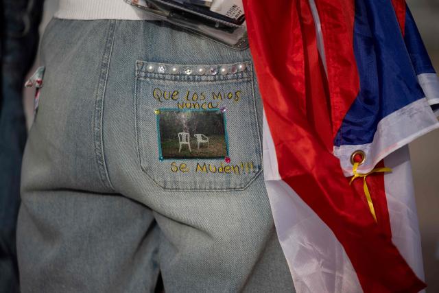 A woman wears pants featuring lyrics from a song by Puerto Rican singer Bad Bunny before the start of the first show of his 30-date concert residency at the Coliseo de Puerto Rico in San Juan, Puerto Rico, on July 11, 2025. (Photo by Ricardo ARDUENGO / AFP)
