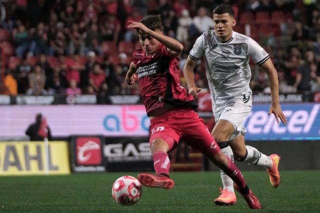 Tijuana's Mexican midfielder #11 Ramiro Arciga (L) fights for the ball with Queretaro's Paraguayan midfielder #28 Rodrigo Bogarin during the Liga MX Clausura football tournament match between Tijuana and Queretaro at Caliente Stadium in Tijuana, Baja California State, Mexico, on July 11, 2025. (Photo by Guillermo Arias / AFP)