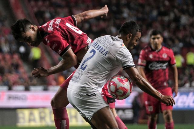 Tijuana's Spanish defender #04 Unai Bilbao (L) fights for the ball with Queretaro's Mexican defender #02 Omar Mendoza during the Liga MX Clausura football tournament match between Tijuana and Queretaro at Caliente Stadium in Tijuana, Baja California State, Mexico, on July 11, 2025. (Photo by Guillermo Arias / AFP)