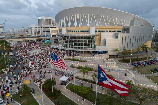 An aerial view shows people queing outside the Coliseo de Puerto Rico to attend the first show of Puerto Rican singer Bad Bunny's 30-date concert residency at the arena in San Juan, Puerto Rico, on July 11, 2025. (Photo by Ricardo ARDUENGO / AFP)