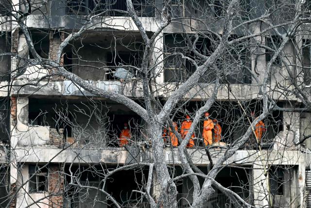 (FILES) National Disaster Response Force (NDRF) personnel inspect the site after Air India flight AI171 crashed in a residential area near the airport in Ahmedabad, on June 13, 2025. Fuel control switches to the engines of an Air India flight that crashed shortly after takeoff, killing 260 people, were moved from the "run" to the "cutoff" position moments before impact, a preliminary investigation report said early on July 12. (Photo by Punit PARANJPE / AFP)