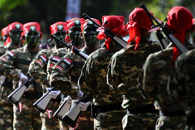 Cadets of the Komponen Cadangan (Komcad), the Reserve Component of the Indonesian National Armed Forces (TNI), take part in a graduation ceremony after three months of military basic training, in Banda Aceh on July 12, 2025. (Photo by CHAIDEER MAHYUDDIN / AFP)