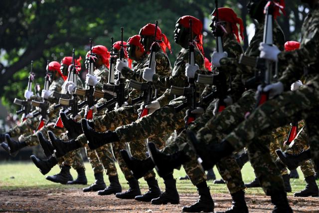 Cadets of the Komponen Cadangan (Komcad), the Reserve Component of the Indonesian National Armed Forces (TNI), take part in a graduation ceremony after three months of military basic training, in Banda Aceh on July 12, 2025. (Photo by CHAIDEER MAHYUDDIN / AFP)