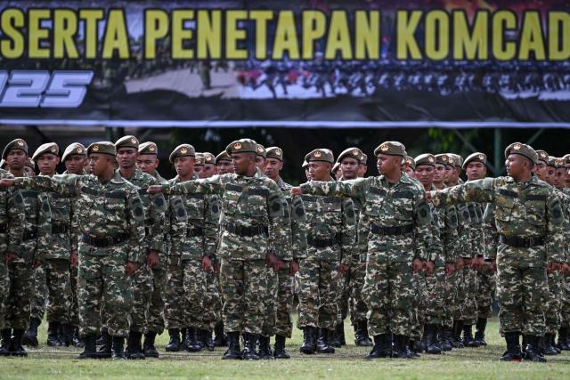 Cadets of the Komponen Cadangan (Komcad), the Reserve Component of the Indonesian National Armed Forces (TNI), take part in a graduation ceremony after three months of military basic training, in Banda Aceh on July 12, 2025. (Photo by CHAIDEER MAHYUDDIN / AFP)