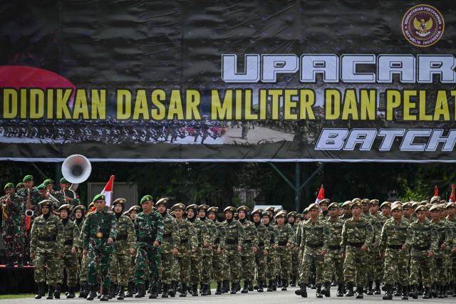 Cadets of the Komponen Cadangan (Komcad), the Reserve Component of the Indonesian National Armed Forces (TNI), take part in a graduation ceremony after three months of military basic training, in Banda Aceh on July 12, 2025. (Photo by CHAIDEER MAHYUDDIN / AFP)
