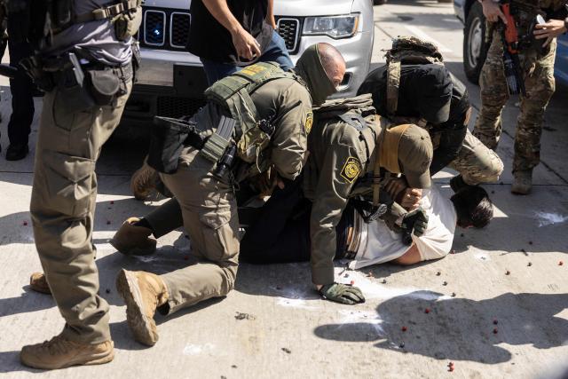 (FILES) A man is detained as clashes break out after US Customs and Border Protection (CBP) officers attempted to raid a store in Bell, just south of Los Angeles, California, on June 20, 2025. A federal judge on July 11 ordered the Trump administration to take measures to prevent racial profiling in Los Angeles, during the violent arrests of migrants that have been increasing in the past month around the Californian metropolis. She ruled in favor of several migrants and two American citizens, as well as the organizations that helped them file a complaint in early July. They claimed they had been victims of racial profiling and also denounced obstructions to accessing legal counsel while in detention. (Photo by ETIENNE LAURENT / AFP)