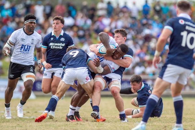Scotland's Jamie Dobie (C) tackles Fiji's Josua Tuisova during the rugby test match between Fiji and Scotland at HFC Bank Stadium in Suva on July 12, 2025. (Photo by Josua BUREDUA / AFP)