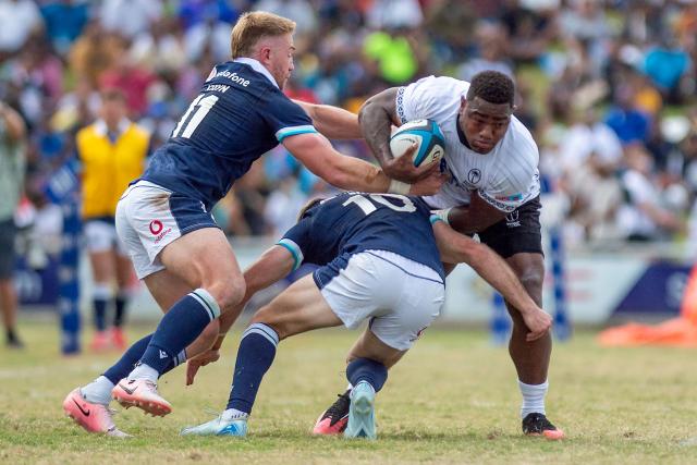 Scotland's Kyle Steyn (L) and Fergus Burke tackles Fiji's Josua Tuisova (R) during the rugby test match between Fiji and Scotland at HFC Bank Stadium in Suva on July 12, 2025. (Photo by Josua BUREDUA / AFP)
