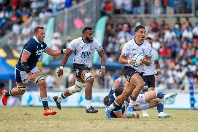 Fiji's Salesi Rayasi (R) runs the ball towards the try line during the rugby test match between Fiji and Scotland at HFC Bank Stadium in Suva on July 12, 2025. (Photo by Josua BUREDUA / AFP)