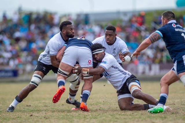 Scotland's Matt Fagerson (C) is tackled by Fiji's  Lekima Tagitagivalu (L) and Kalaveti Ravouvou during the rugby test match between Fiji and Scotland at HFC Bank Stadium in Suva on July 12, 2025. (Photo by Josua BUREDUA / AFP)