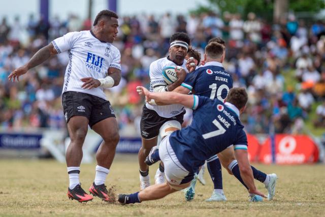 Scotland's Fergus Burke tackles Fiji's Kalaveti Ravouvou (C) during the rugby test match between Fiji and Scotland at HFC Bank Stadium in Suva on July 12, 2025. (Photo by LEON LORD / AFP)