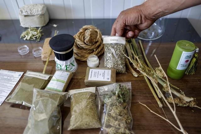 A man shows various industrial hemp products at Biocannat, a cannabis processing factory in Bab Berred, southeast of Morocco's rural northern province of Chefchaouen, on July 11, 2025. Morocco passed a law in 2021 allowing the cultivation of medical and industrial-use cannabis in areas of Rif, a mountainous region that has long been a major source of illicit hashish, a stronger derivative of cannabis, smuggled to Europe. (Photo by Abdel Majid BZIOUAT / AFP)