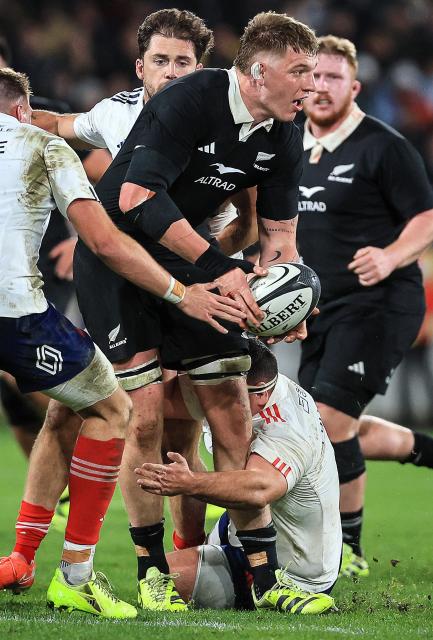 New Zealand's Fabian Holland looks to offload the ball during the second international rugby test match between New Zealand and France at Sky Stadium in Wellington on July 12, 2025. (Photo by Grant Down / AFP)