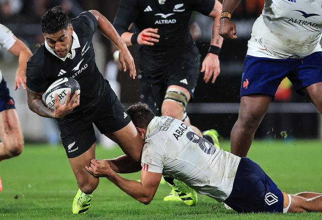 New Zealand's Rieko Ioane (L) is tackled by Esteban Abadie of France during the second international rugby test match between New Zealand and France at Sky Stadium in Wellington on July 12, 2025. (Photo by Grant Down / AFP)