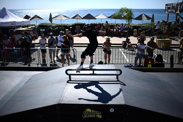 A boy takes part in a skateboarding event as part of the Lacanau Pro World Surf League (WSL) event along the Atlantic Ocean in Lacanau, south-western France on July 11, 2025, as surf competitions are suspended due to a lack of swell. For nearly fifty years, the Lacanau Pro has withstood all the upheavals in the surf industry to become the last major international gathering in mainland France. (Photo by Christophe ARCHAMBAULT / AFP)