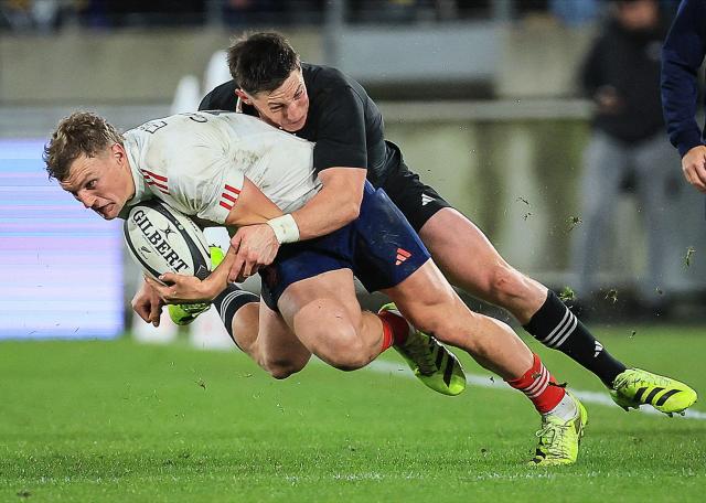 Émilien Gailleton of France is tackled by New Zealand's Cam Roigard during the second international rugby test match between New Zealand and France at Sky Stadium in Wellington on July 12, 2025. (Photo by Grant Down / AFP)