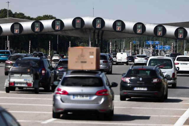 This photograph shows vehicles queueing at the Saint-Arnoult-en-Yveline toll gate on the A10 highway, south of Paris, on July 12, 2025. (Photo by Thibaud MORITZ / AFP)