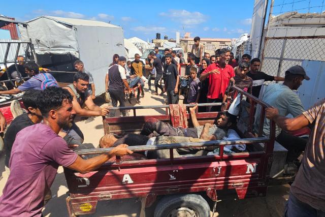 EDITORS NOTE: Graphic content / Palestinians transport victims to a Red Cross clinic in Rafah in the southern Gaza Strip after they were reportedly shot as they waited to receive food parcels at a distribution point run by the US and Israel-backed Gaza Humanitarian Foundation (GHF), on July 12, 2025. Gaza's civil defence agency said at least 14 Palestinians were killed in the latest wave of Israeli strikes across the territory on July 12. (Photo by AFP)