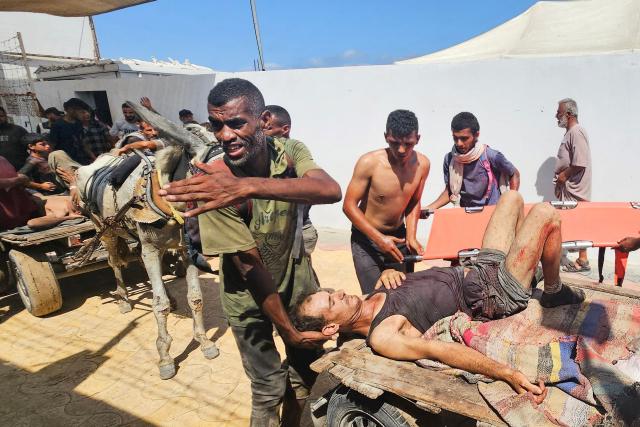 Palestinians transport victims to a Red Cross clinic in Rafah in the southern Gaza Strip after they were reportedly shot as they waited to receive food parcels at a distribution point run by the US and Israel-backed Gaza Humanitarian Foundation (GHF), on July 12, 2025. Gaza's civil defence agency said at least 14 Palestinians were killed in the latest wave of Israeli strikes across the territory on July 12. (Photo by AFP)