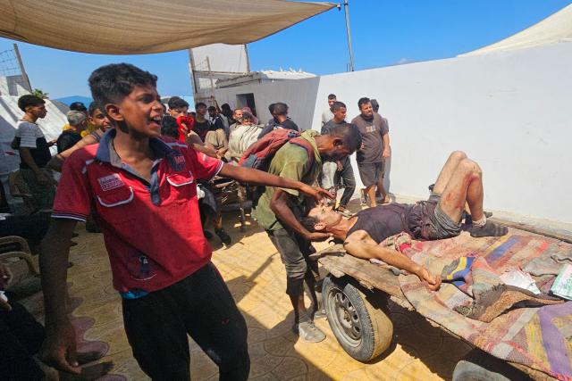 Palestinians transport victims to a Red Cross clinic in Rafah in the southern Gaza Strip after they were reportedly shot as they waited to receive food parcels at a distribution point run by the US and Israel-backed Gaza Humanitarian Foundation (GHF), on July 12, 2025. Gaza's civil defence agency said at least 14 Palestinians were killed in the latest wave of Israeli strikes across the territory on July 12. (Photo by AFP)